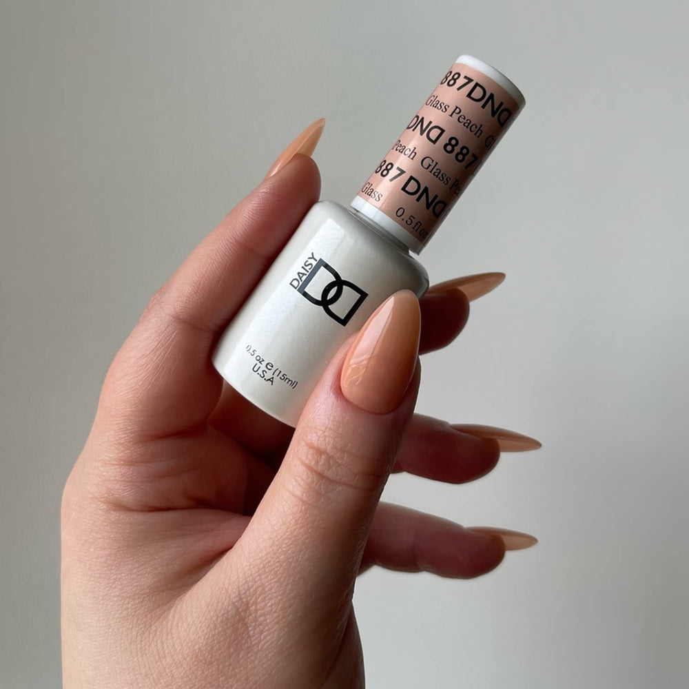 Daisy DND Glass Peach lacquer bottle paired with gel polish for a coordinated mani option.