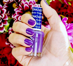 DAISY DND Monster Purple 657 gel bottle beside lacquer for a color-matched finish.