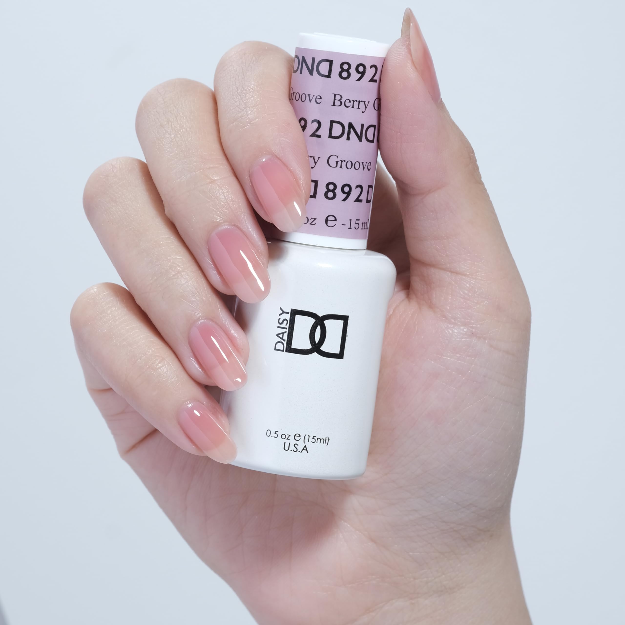 Daisy DND Berry Groove nails shown in a sheer red mani with natural shine