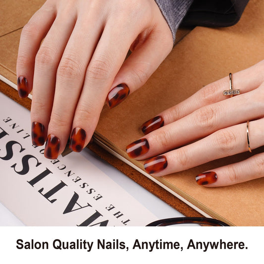 DANNI & TONI cheetah-pattern nail strips close-up showcasing bold salon-style nails at home.