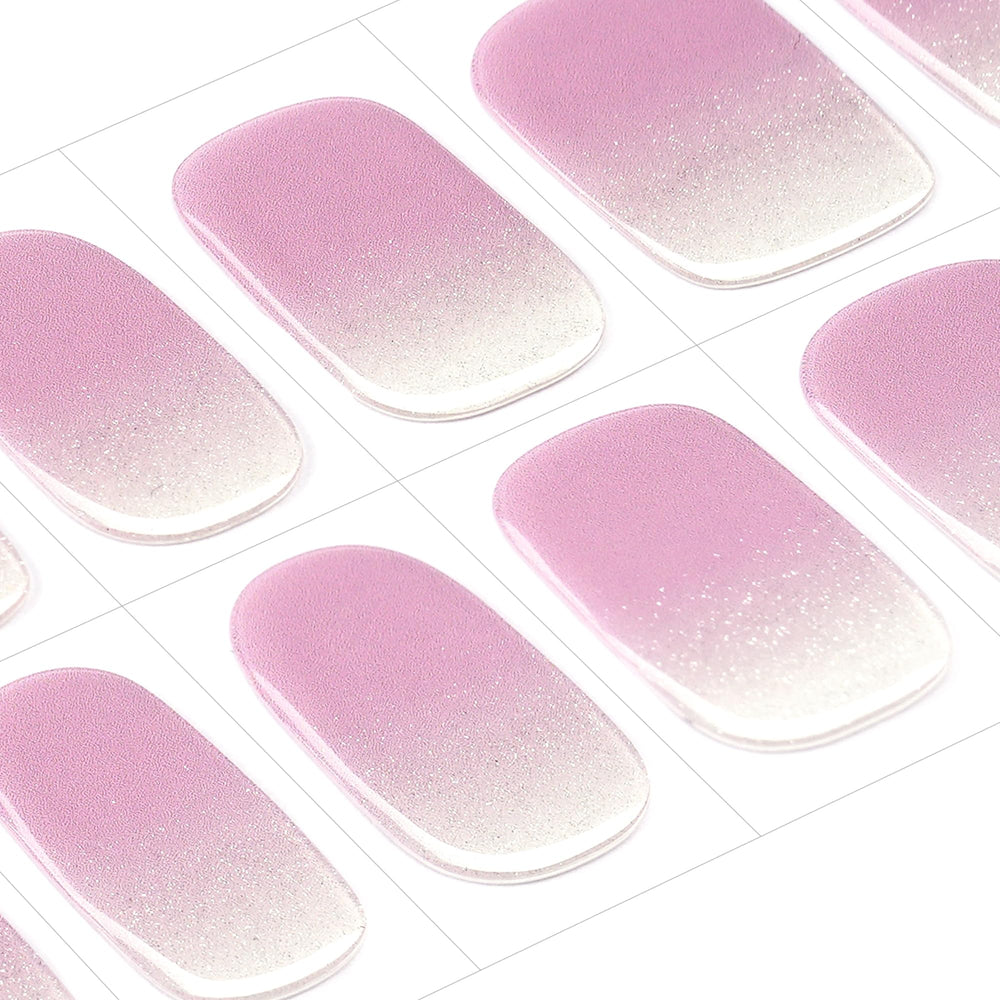 Close-up of lavender gradient design with fine glitter on gel wraps.
