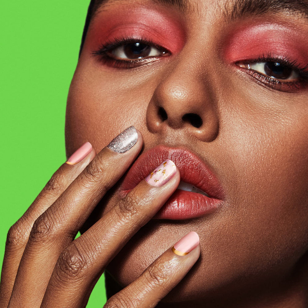 Dashing Diva Feeling Flush close-up on nails reveals pink champagne glitter and gold accents.