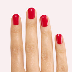 Close-up of Dashing Diva Red Dahlia gloss nail strip on nail.