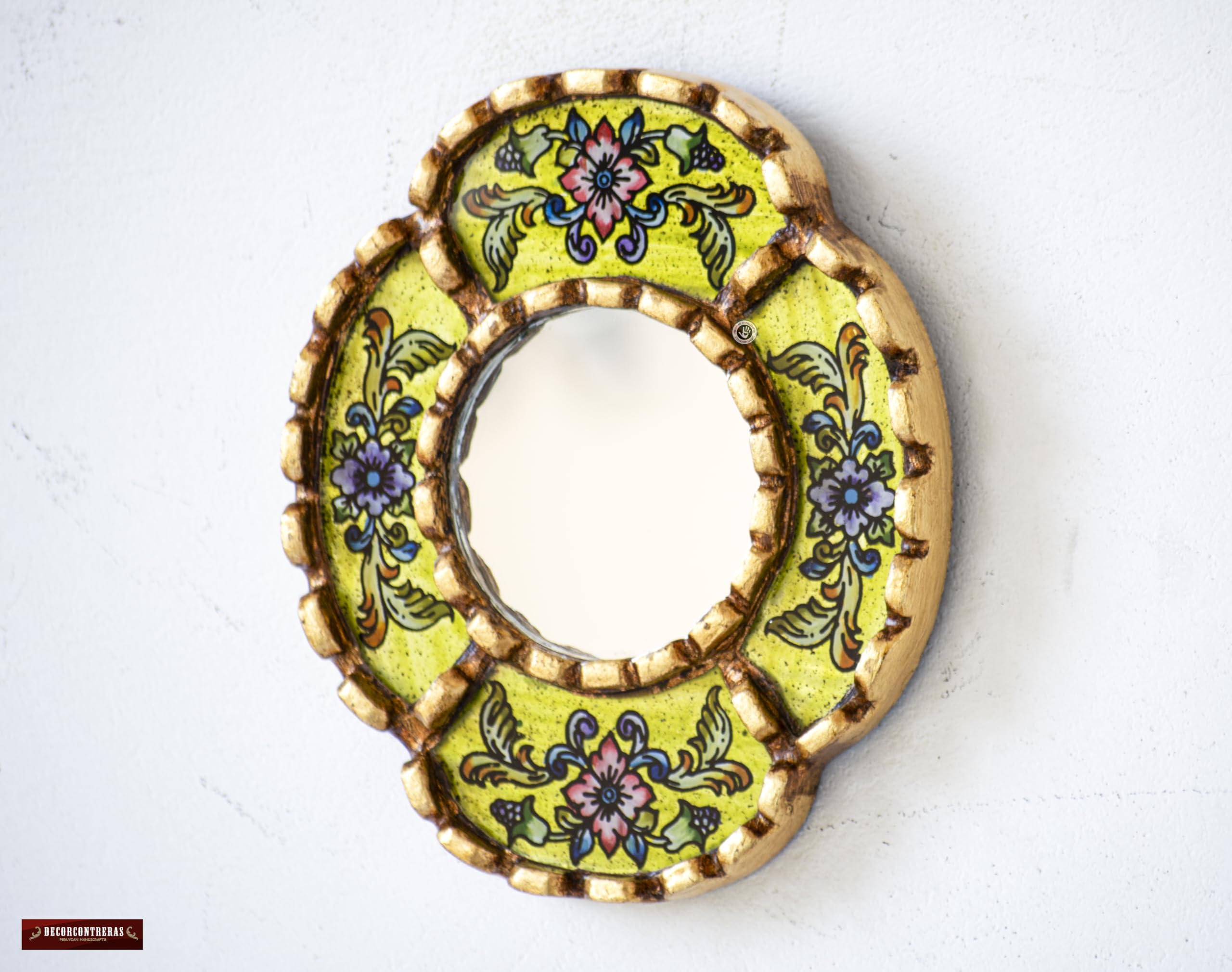 DecorContreras oval mirror showcases textured floral brushstrokes and warm color.