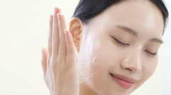 Applying DEEOM Real Yam Brightening Toner on the face with a cotton pad for hydration