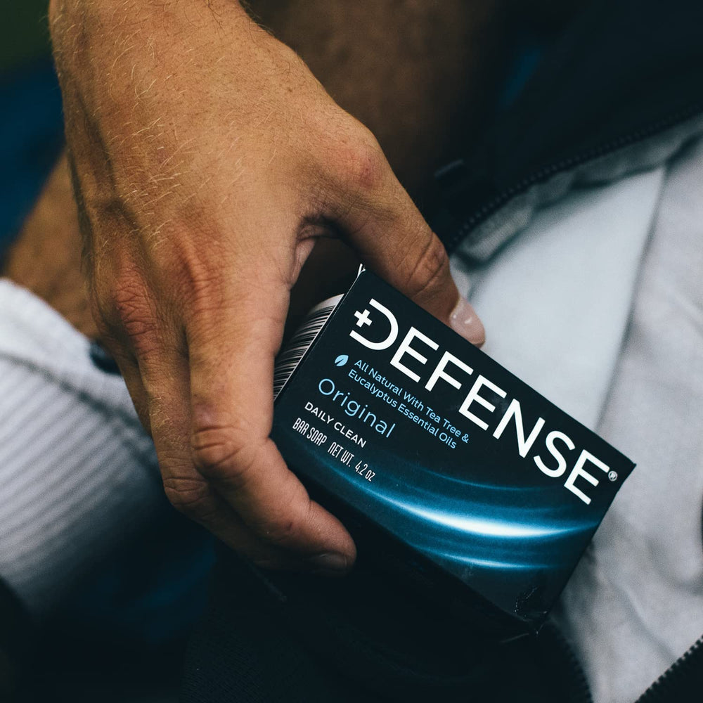 Hands washing with Defense Soap bar to remove sweat and grime