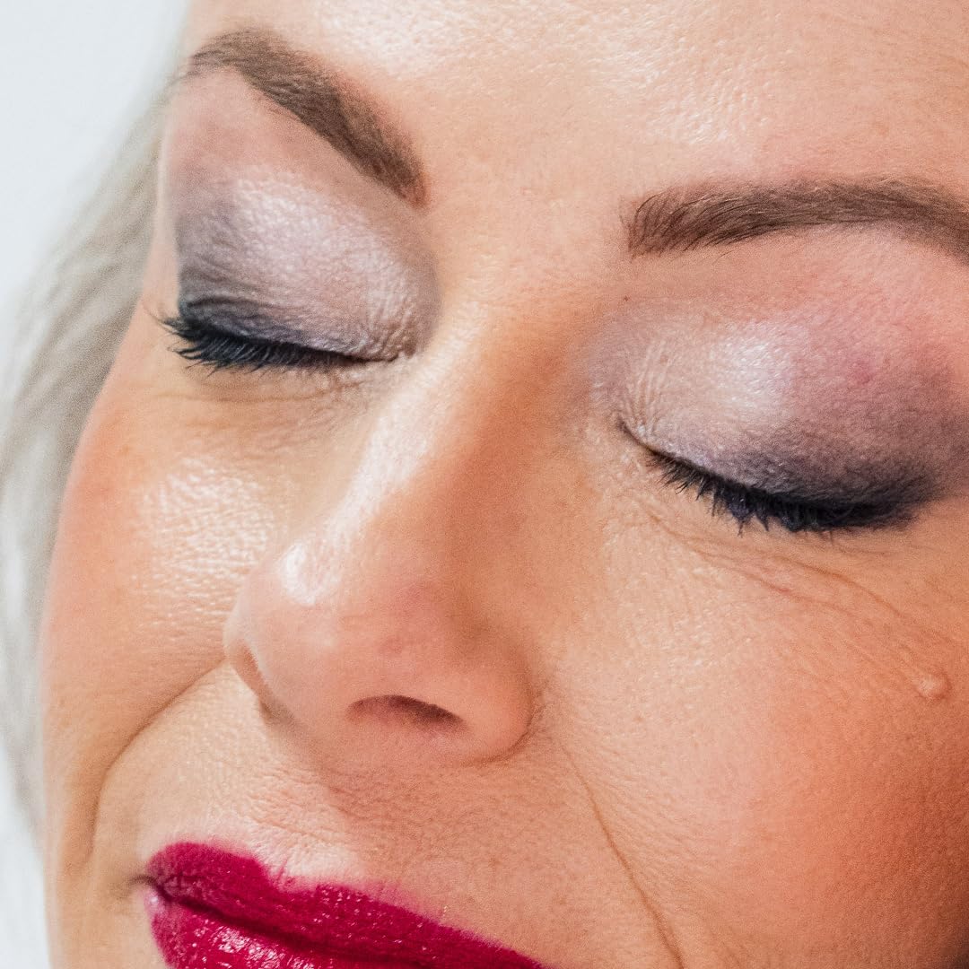 Applying Demúre mineral eye shadow with a soft brush for blending.