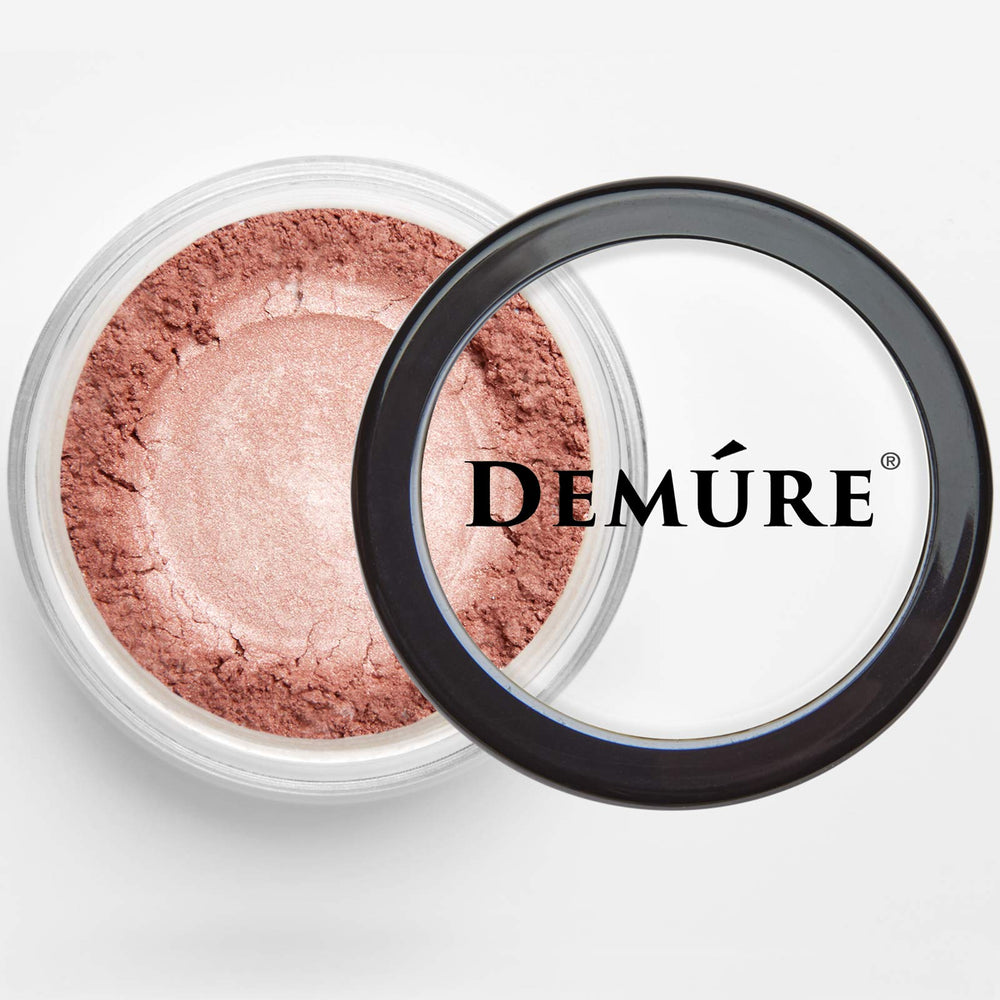 Demure Glitter Eye Shadow compact closeup shows luminous particles for day-to-night wear.