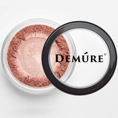 Demure Glitter Eye Shadow compact closeup shows luminous particles for day-to-night wear.