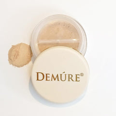 DEMÚRE Demure Mineral Concealer swatch on hand with yellow-toned camouflage.