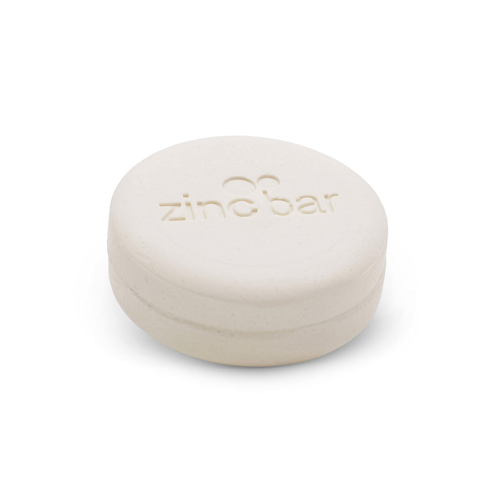 DermaHarmony pyrithione zinc bar close-up with visible lather for gentle cleansing.