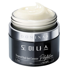 DOMINAS dark spot corrector bottle close-up showing brightening formula for even skin tone