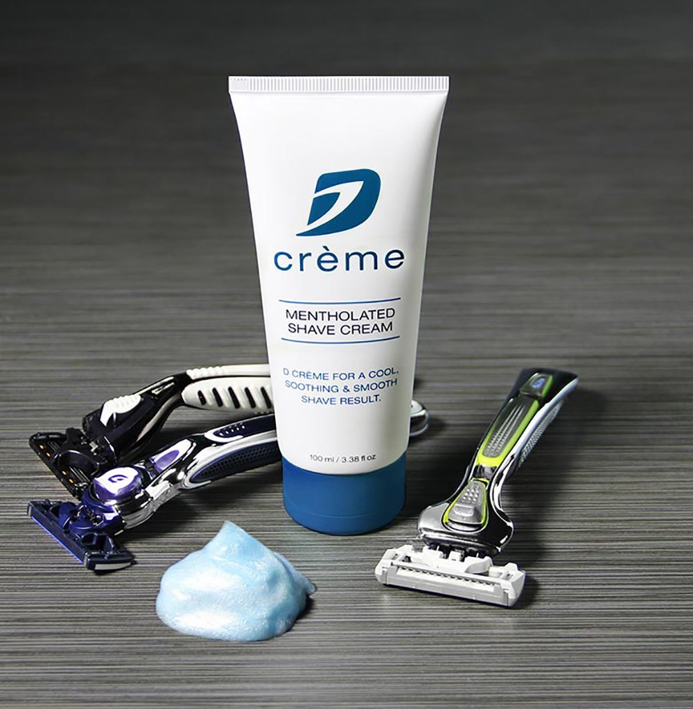Dorco D Crème mentholated shaving cream tube application showing lotion-like glide for sensitive skin.