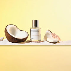 Dossier Powdery Coconut bottle on wood, suggesting sophisticated evening wear