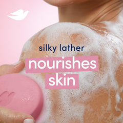 Hands lathering Dove Pink Beauty Bar for smooth skin after rinsing.