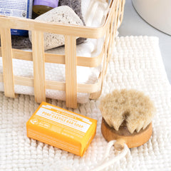 Lathering citrus bar soap in shower for body cleansing