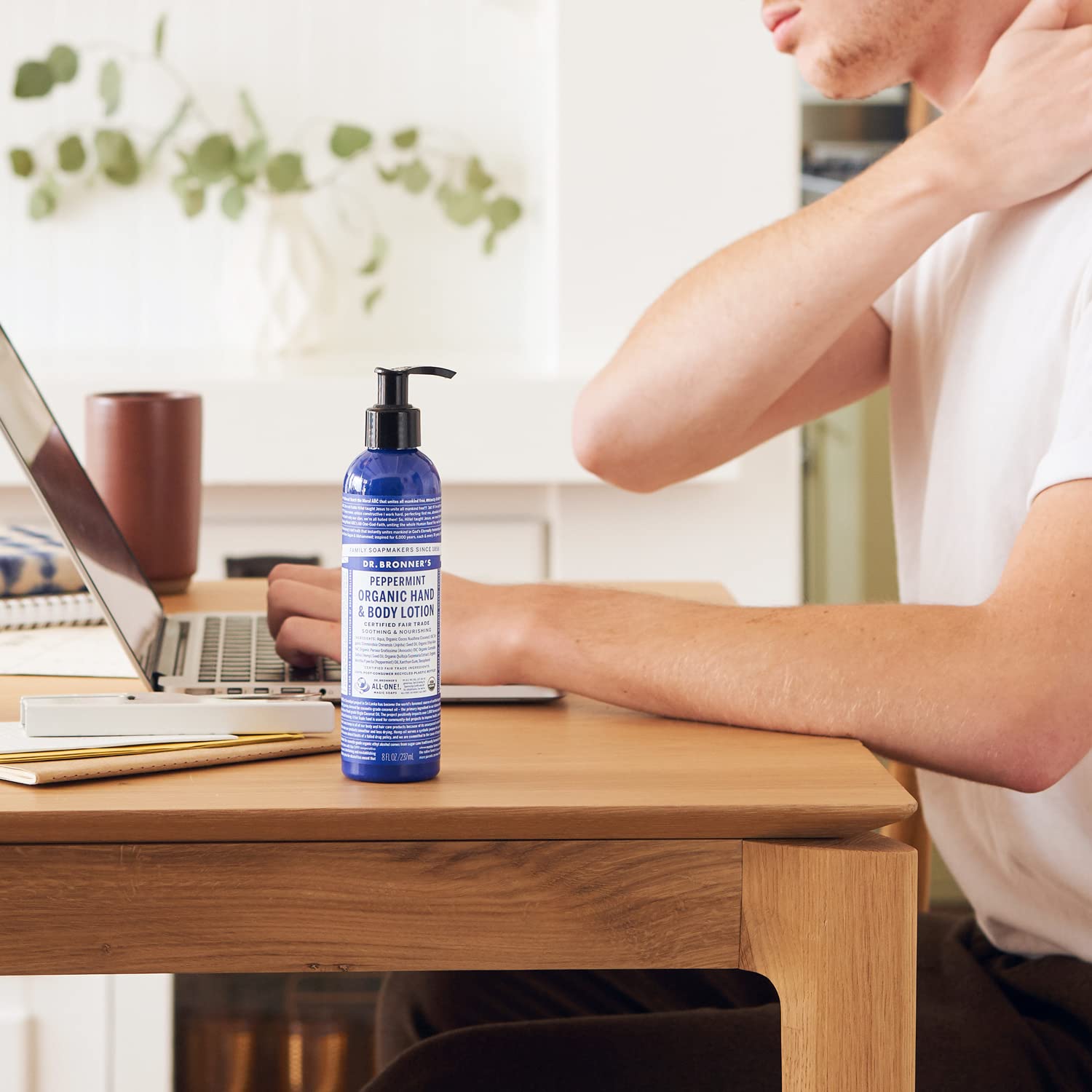 Applying Dr. Bronner's Peppermint Lotion to hands for quick, softening moisture.