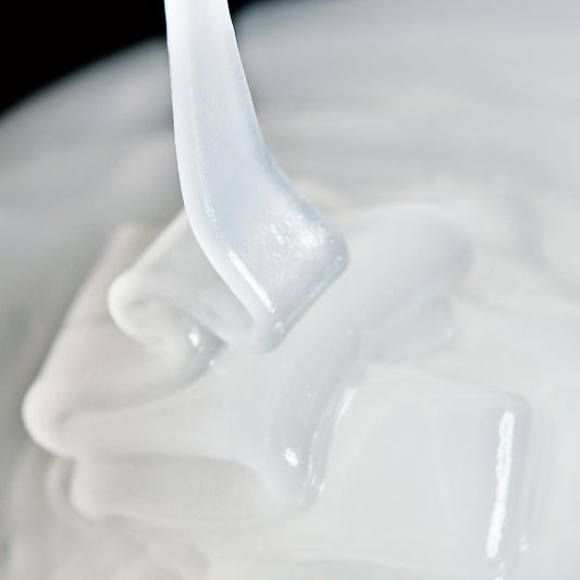 Close-up of InstaFacial Emulsion jar showing creamy texture for smoothing application.