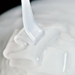 Close-up of InstaFacial Emulsion jar showing creamy texture for smoothing application.