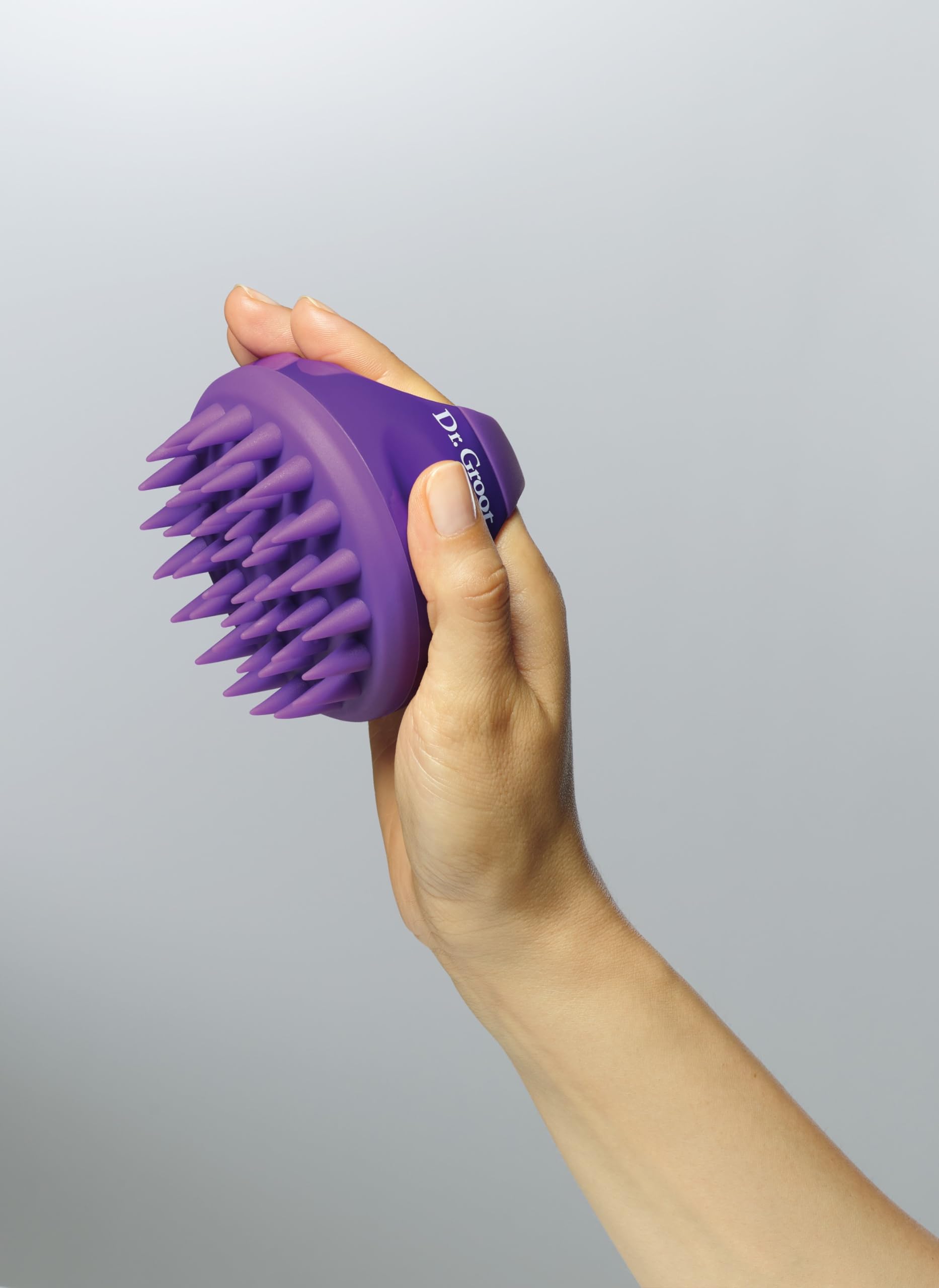 Dr. Groot in-use on wet hair massaging scalp, improves shampoo lather