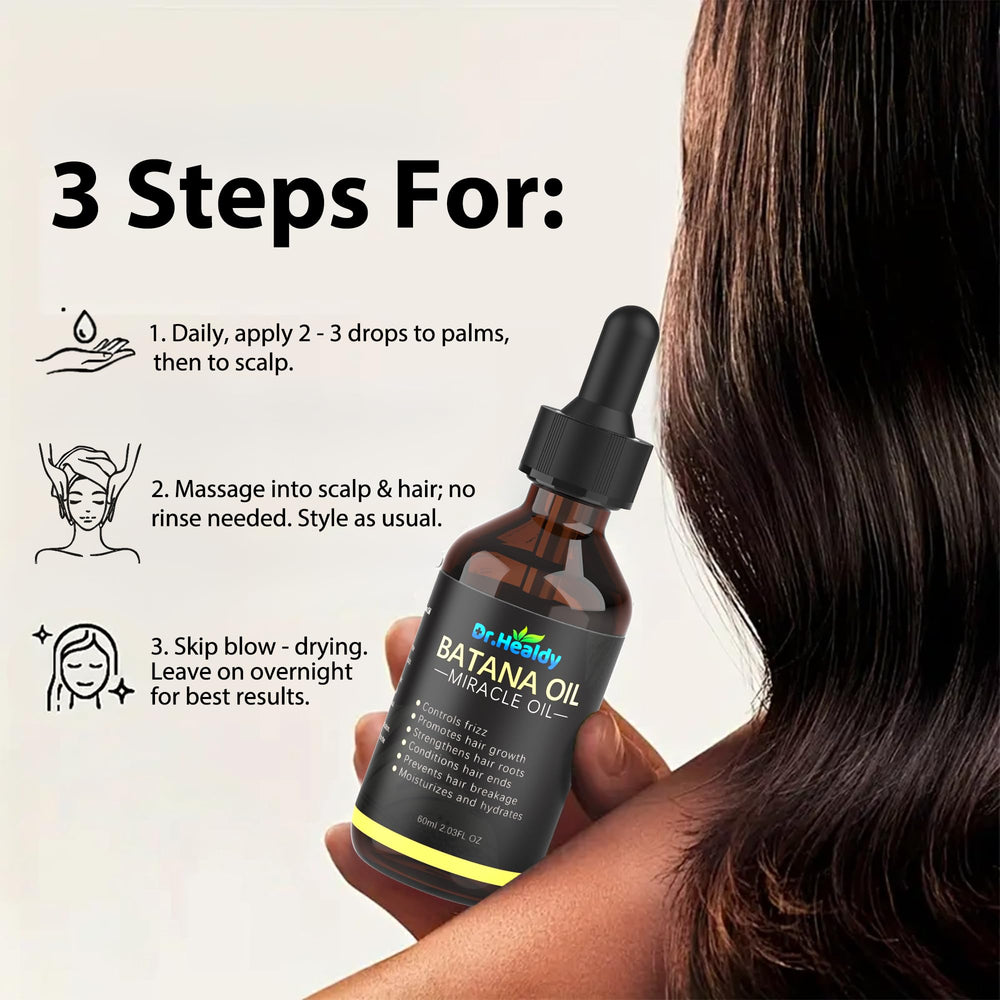 Dr. Healdy Batana Oil on hair strands to combat dryness and soften ends.