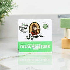 Dr. Squatch Total Moisture bar soap in hand suggests a simple, refreshing daily cleanse.