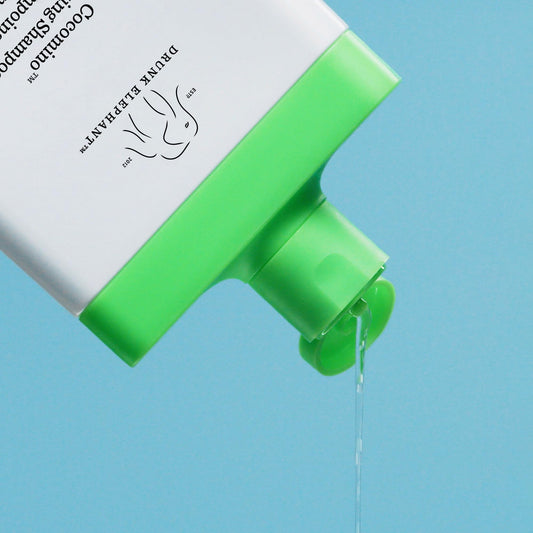 Cocomino glossing shampoo lather highlighting rich foam and easy rinse for smooth hair.