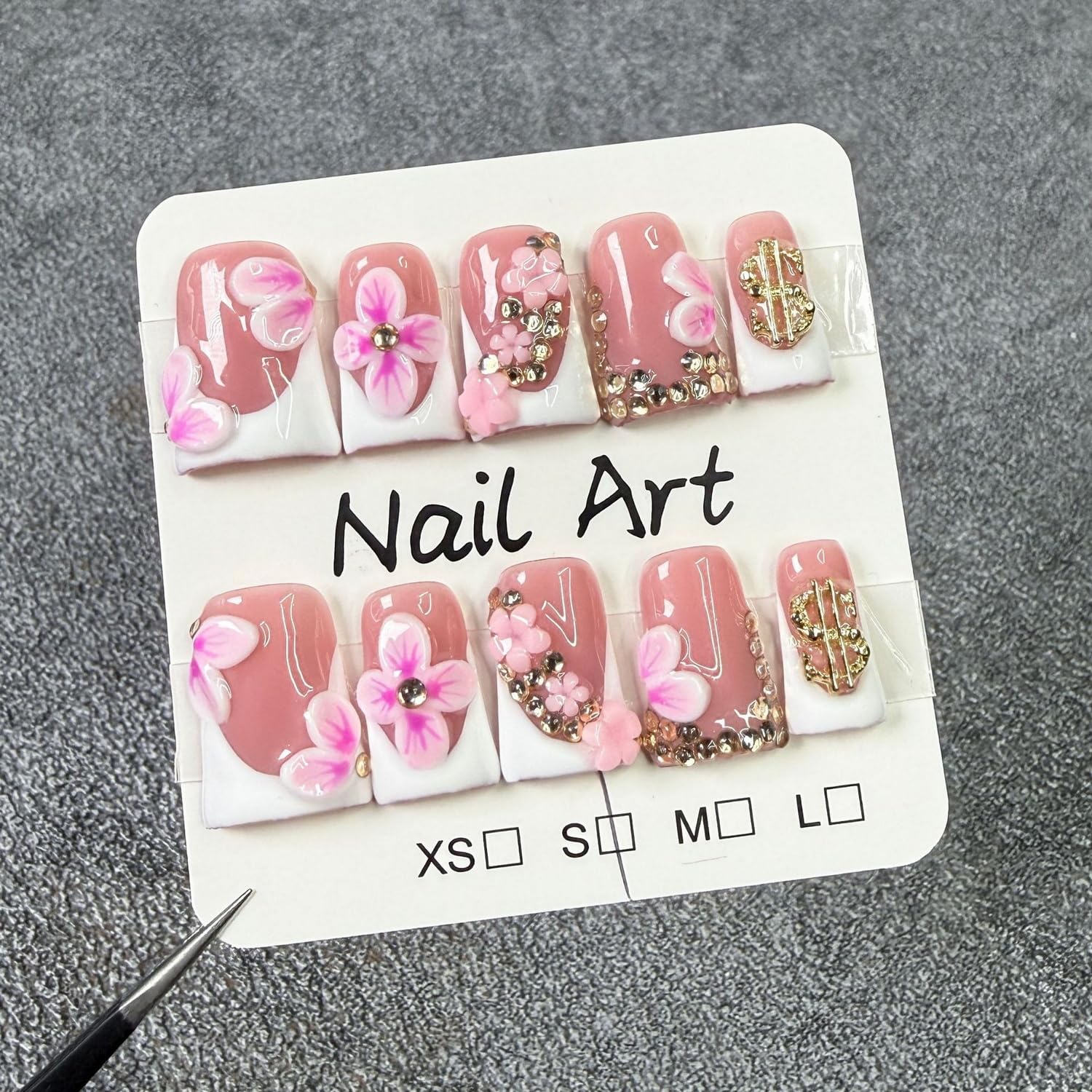 Closeup of gold rhinestones on Duckbill nails for a sparkling look