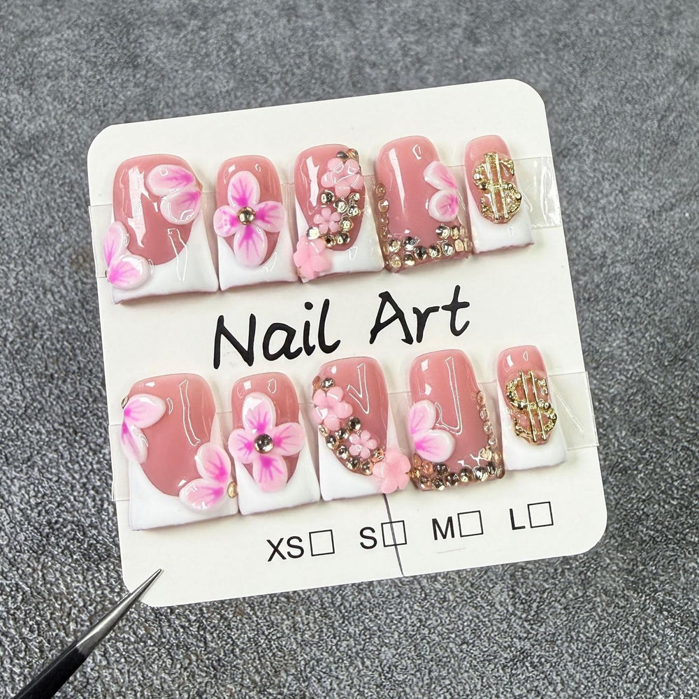 Closeup of gold rhinestones on Duckbill nails for a sparkling look
