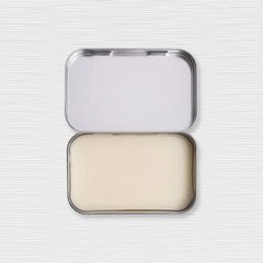 Duke Cannon Old Glory solid cologne open tin revealing tobacco, amber, leather notes.