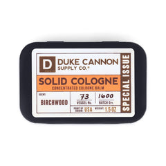 Duke Cannon Birchwood tin in leather briefcase demonstrates travel-friendly fragrance.