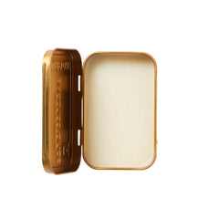 Close-up of Duke Cannon Bourbon solid cologne tin for precise, mess-free application.