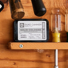 Duke Cannon solid cologne evening mood evoking green-field walk.