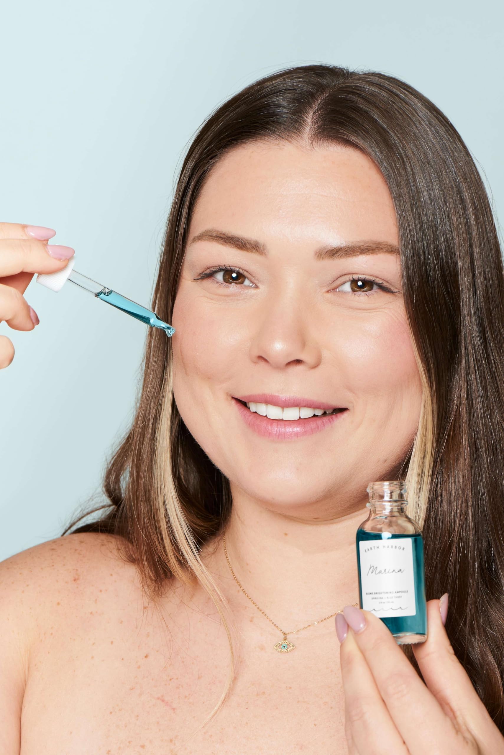 Earth Harbor Marina Biome Ampoule being applied to the hand for radiant look