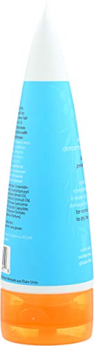 Applying Earth Science shampoo to dry hair to demonstrate targeted nourishment