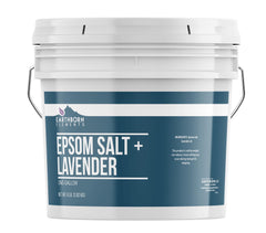 Earthborn Elements Lavender Epsom Salt bottle on a bath shelf for relaxing soaks.