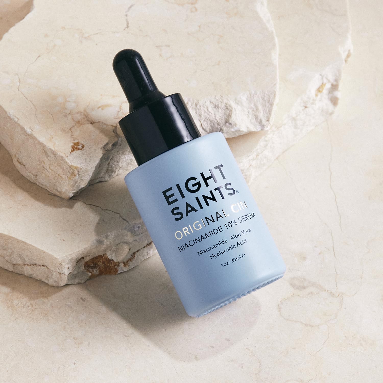 Close-up of Eight Saints serum bottle highlighting 10% niacinamide for even skin tone.