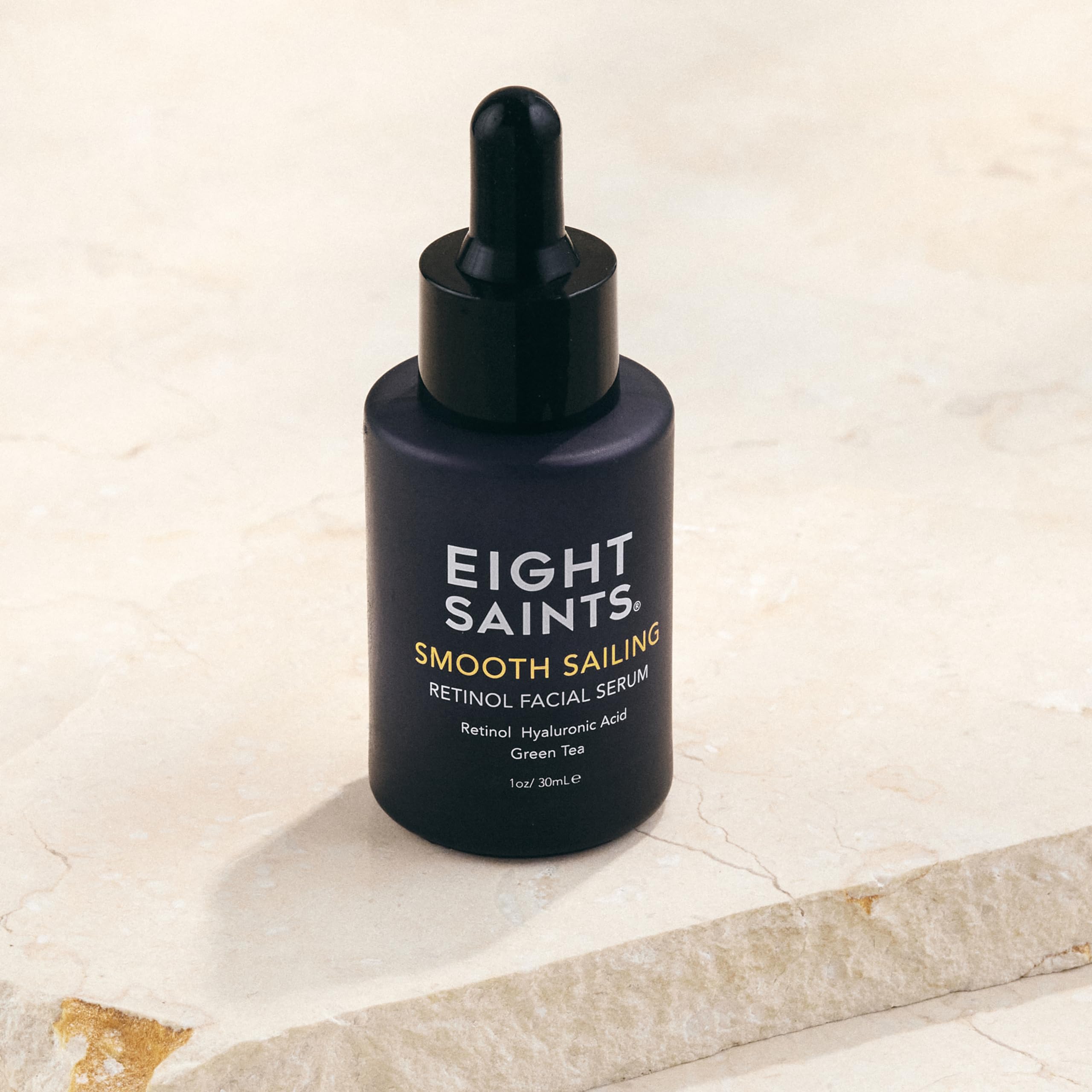 Applying Eight Saints serum to face and neck for gentle hydration.