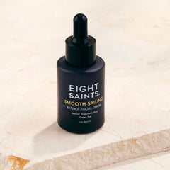 Applying Eight Saints serum to face and neck for gentle hydration.