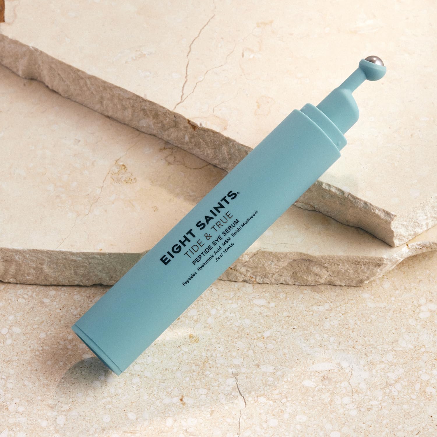 Eight Saints Tide & True eye serum roller in use for depuffing under-eye area