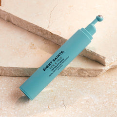 Eight Saints Tide & True eye serum roller in use for depuffing under-eye area