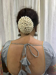 Elegant white gajra jewelry for mehndi, adds timeless traditional charm.