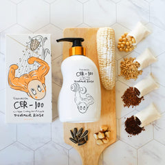 Elizavecca Collagen Coating Hair Treatment 500ml bottle on vanity for routine care.