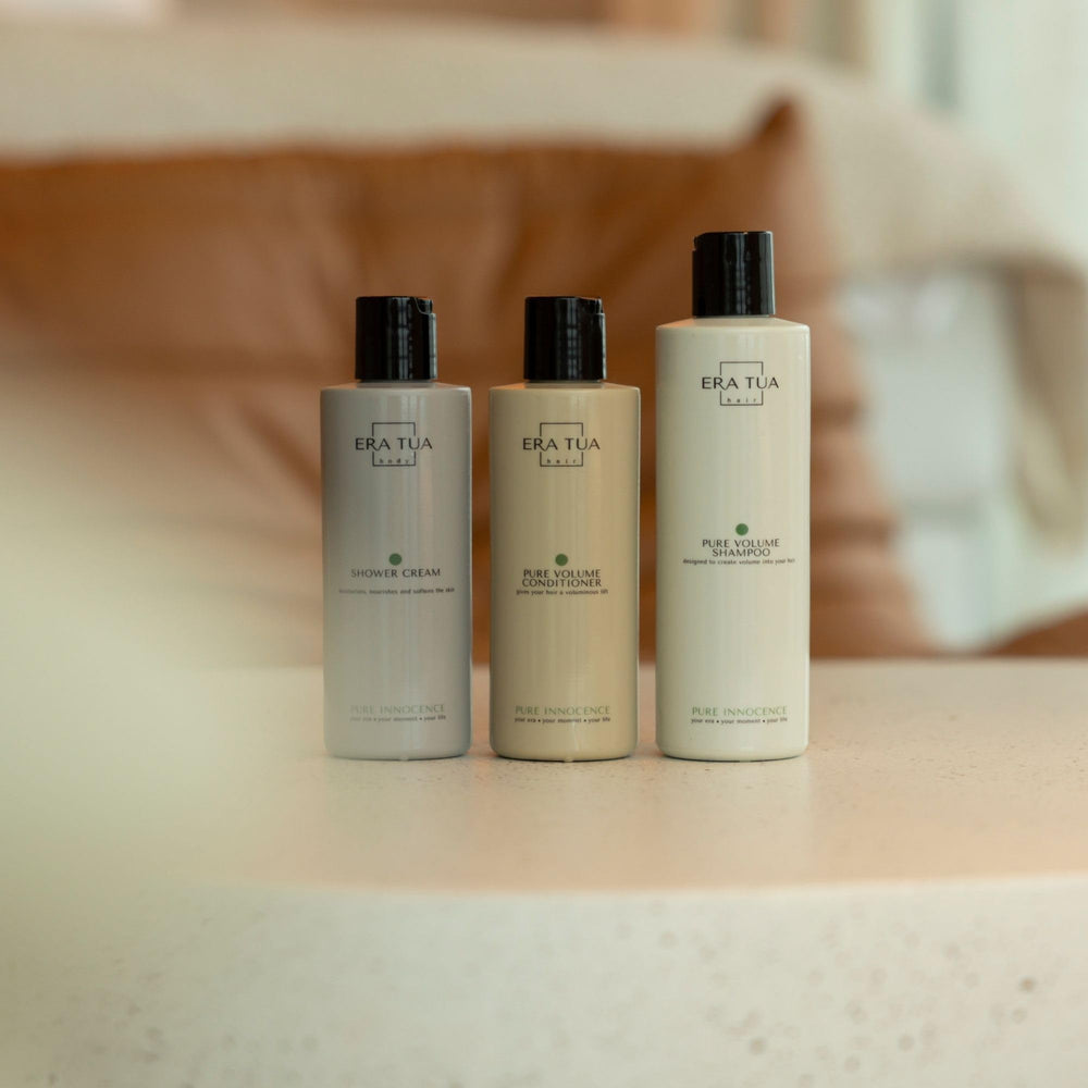 ERA TUA Pure Innocence Volume Shampoo bottle on shelf for daily use