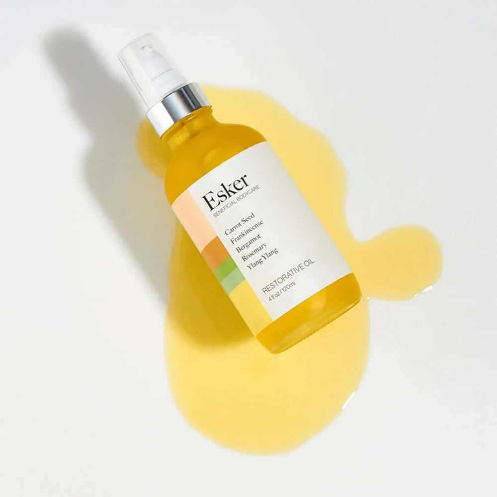 ESKER Restorative Body Oil application scene suggests daily ritual for skin nourishment.