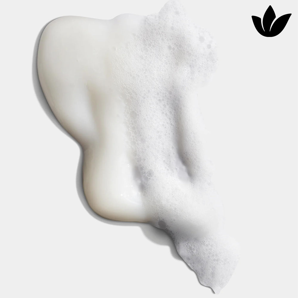 Shampoo bottle with splash suggesting refreshing, hydrating cleanse