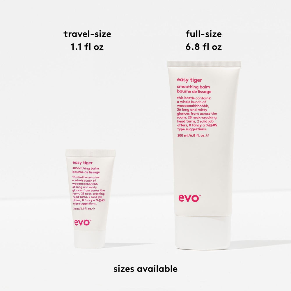 Hands applying EVO Easy Tiger balm to damp hair for even distribution.