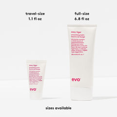 Hands applying EVO Easy Tiger balm to damp hair for even distribution.