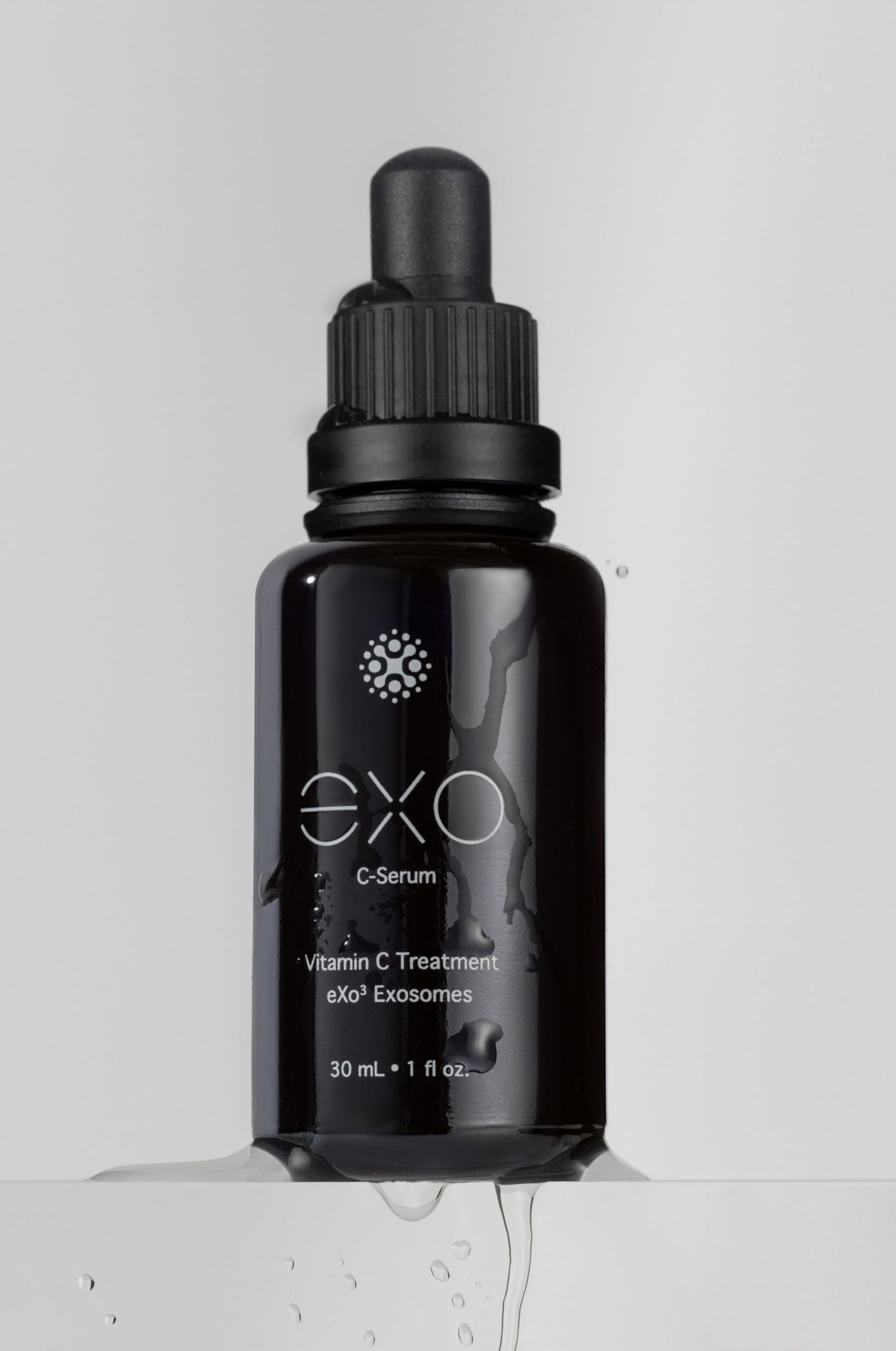 EXO C-SERUM application tapping to aid absorption and evening tone.