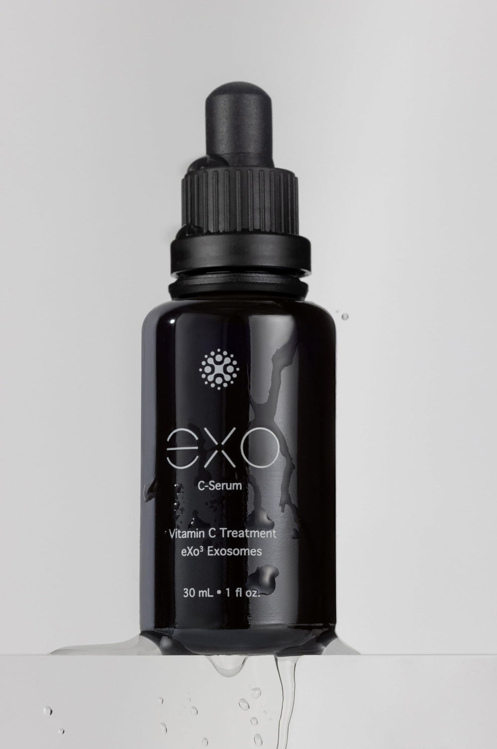 EXO C-SERUM application tapping to aid absorption and evening tone.